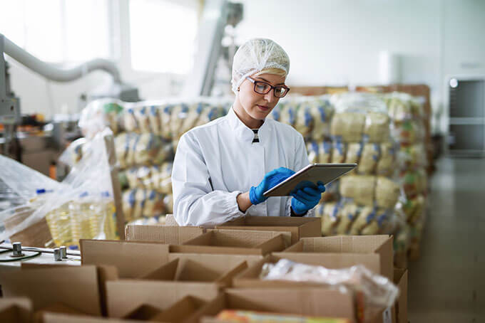 Checking packages in a food production workshop with a tablet